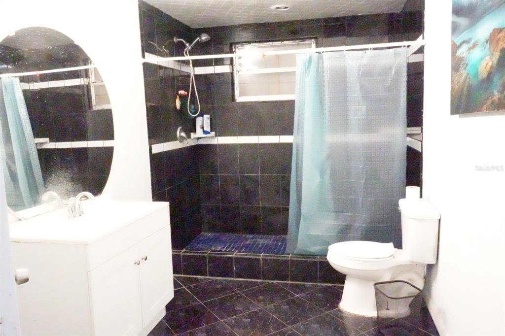 7040 Lumberton Road Zephyrhills, FL 33540 - Photo 12 of 34 a bathroom with a toilet and a shower