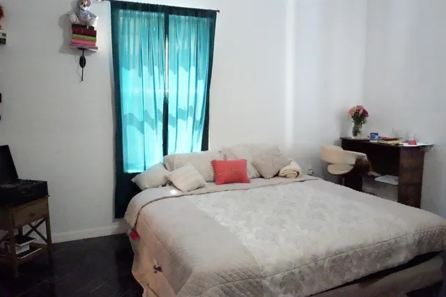 a bedroom with a bed and a window
