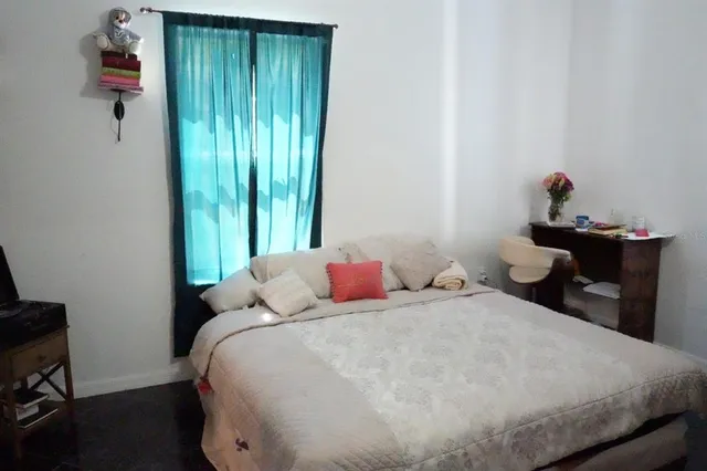 a bedroom with a bed and a window