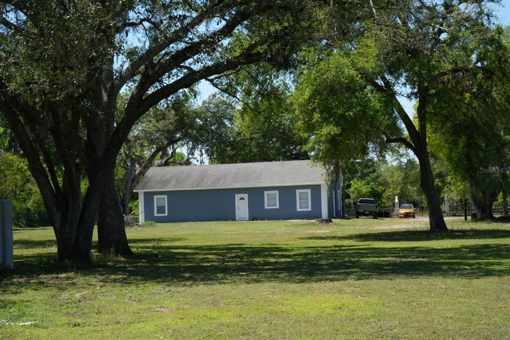 7040 Lumberton Road Zephyrhills, FL 33540 - Photo 18 of 34 a front view of a house with a yard