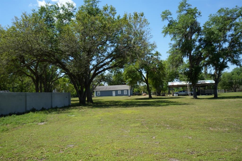 7040 Lumberton Road Zephyrhills, FL 33540 - Photo 19 of 34 a front view of a house with a yard