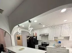 a kitchen with stainless steel appliances kitchen island granite countertop a sink and cabinets
