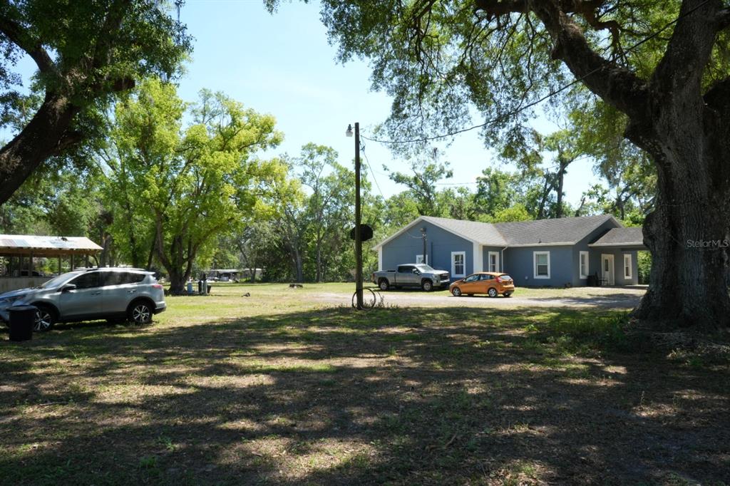 7040 Lumberton Road Zephyrhills, FL 33540 - Photo 24 of 34 a house view with a garden space