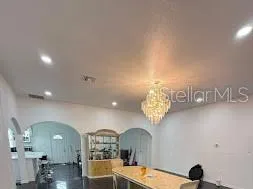 a view of a room that has a table and chairs in it