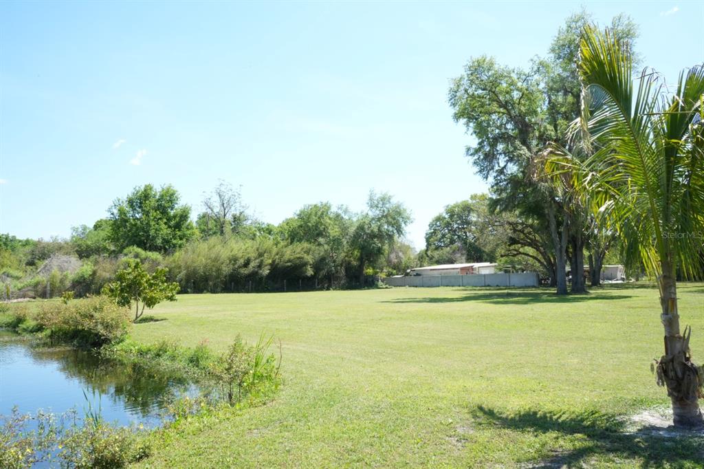 7040 Lumberton Road Zephyrhills, FL 33540 - Photo 26 of 34 a view of a lake with a trees