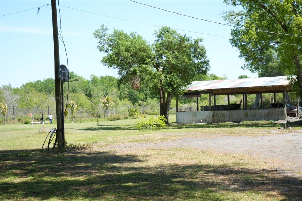 7040 Lumberton Road Zephyrhills, FL 33540 - Photo 27 of 34 a view of a house with a yard