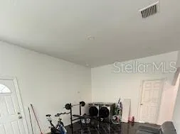 a room with gym equipment and view of living room