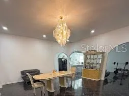 a view of a dining room with furniture and chandelier