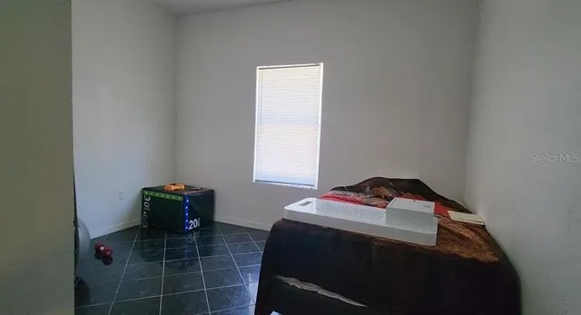 a bedroom with a bed and a window