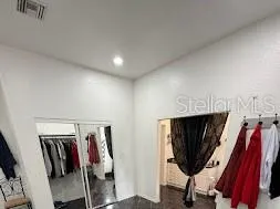 a view of walk in closet with clothes