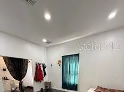 a view of walk in closet with clothes