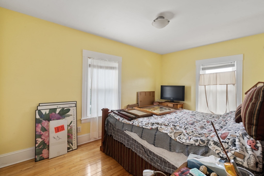 68 Edgewater Road Hull, MA 02045 - Photo 16 of 39 a bedroom with a bed and a flat tv screen on dresser