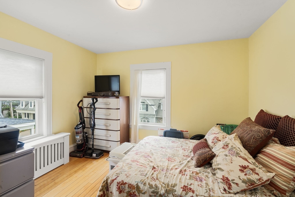 68 Edgewater Road Hull, MA 02045 - Photo 18 of 39 a bedroom with a bed and wooden floor