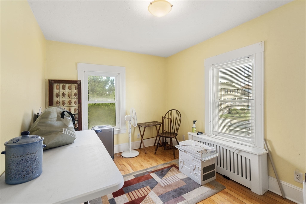 68 Edgewater Road Hull, MA 02045 - Photo 19 of 39 a living room with furniture a flat screen tv and a window
