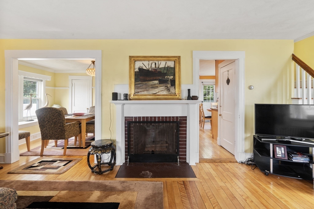 68 Edgewater Road Hull, MA 02045 - Photo 4 of 39 a living room with furniture a flat screen tv and a fireplace
