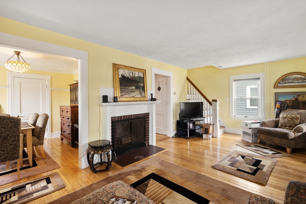 68 Edgewater Road Hull, MA 02045 - Photo 5 of 39 a living room with furniture and a fireplace