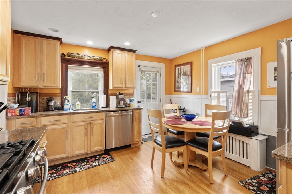 68 Edgewater Road Hull, MA 02045 - Photo 8 of 39 a kitchen with stainless steel appliances kitchen island granite countertop furniture and a large window