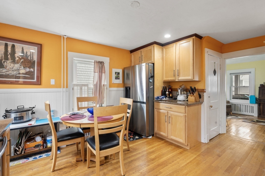68 Edgewater Road Hull, MA 02045 - Photo 10 of 39 a kitchen with stainless steel appliances kitchen island granite countertop a table and chairs in it