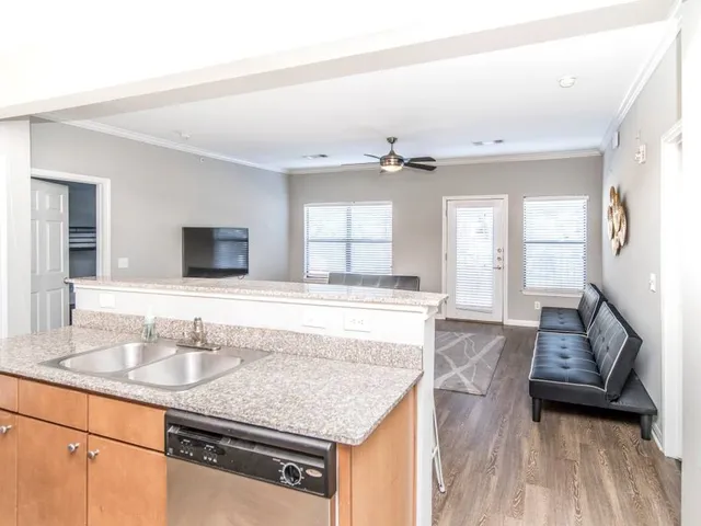 a bathroom with a granite countertop sink a mirror and vanity