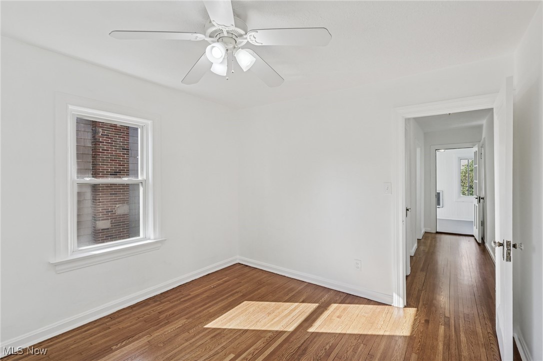 3621 Cedarbrook Road Cleveland, OH 44118 - Photo 21 of 40 Empty room with dark wood-style floors and a ceiling fan