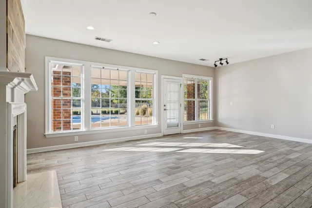 a view of empty room with a fireplace and fan