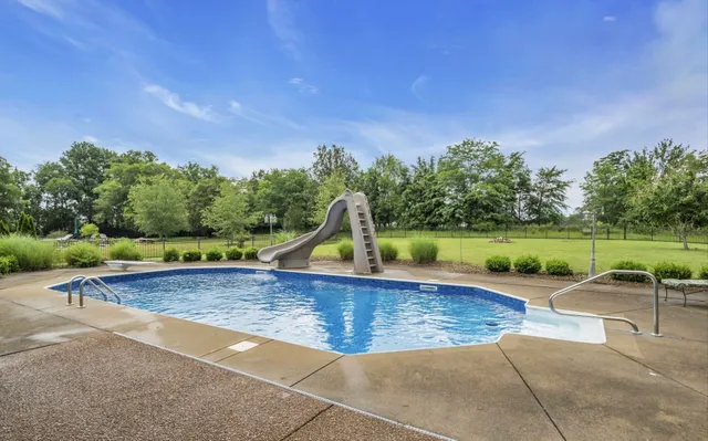 a view of outdoor space with swimming pool and seating