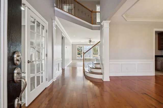 a view of an entryway with wooden floor