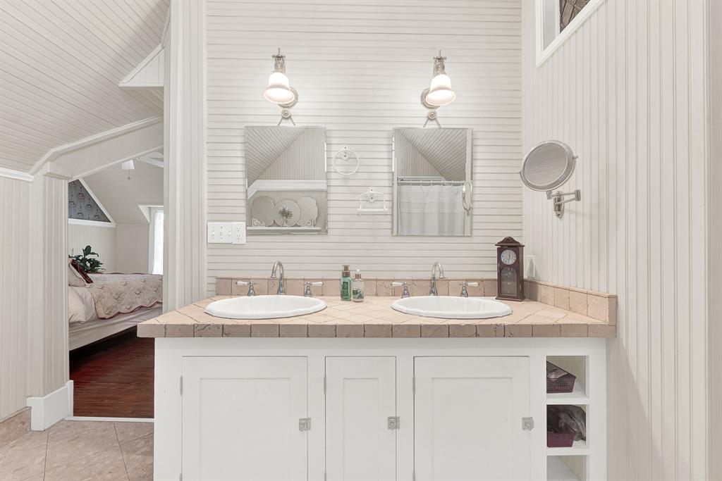 1425 Lone Star Road Celina, TX 75009 - Photo 16 of 40 Dual vanities framed by crisp beadboard walls offer classic styling with the convenience of a thoughtfully updated design. Mornings flow with ease when everyone has their own space to prepare for the day.