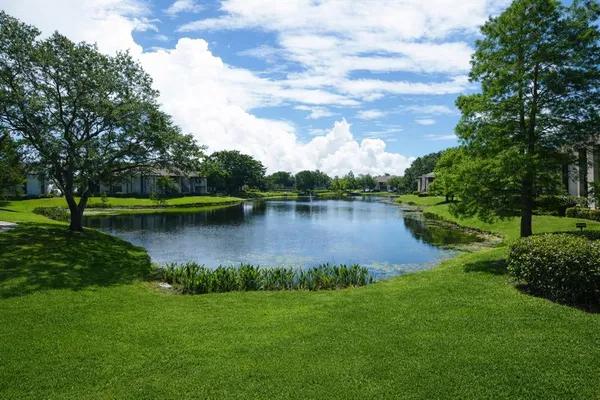a view of a lake with houses in the back
