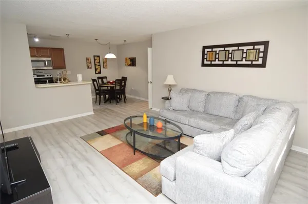 a bedroom with a bed and a flat tv screen on dresser