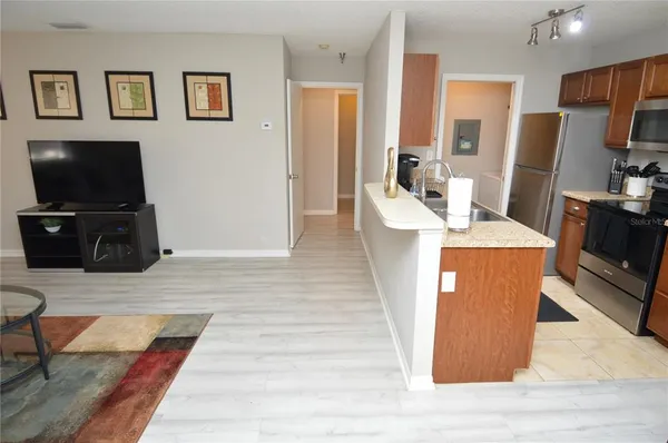 a bedroom with a bed and a flat tv screen on dresser