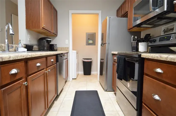 a living room with furniture and kitchen view