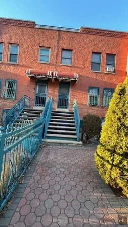 a view of a house with iron fence