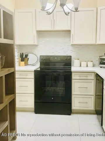 a kitchen with a sink and a black white wooden cabinets