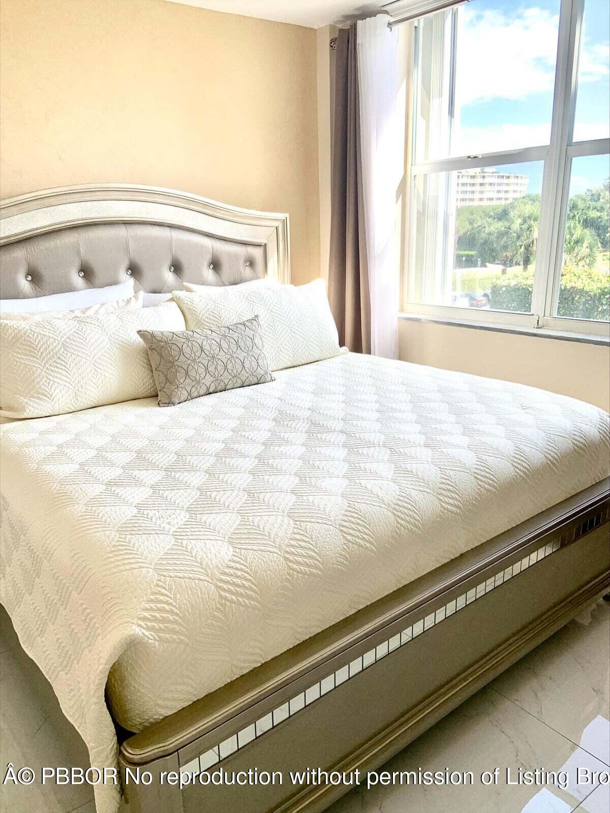 2840 South Ocean Boulevard, Unit 3170 Palm Beach, FL 33480 - Photo 18 of 30 a large bed sitting in a bedroom next to a window