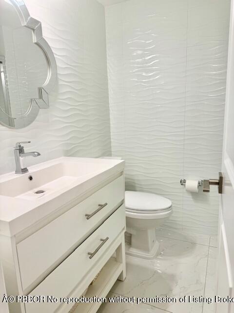 2840 South Ocean Boulevard, Unit 3170 Palm Beach, FL 33480 - Photo 19 of 30 a bathroom with a sink a toilet and mirror