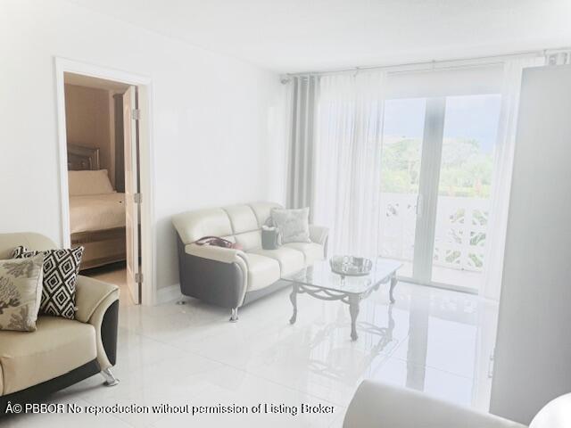 2840 South Ocean Boulevard, Unit 3170 Palm Beach, FL 33480 - Photo 2 of 30 a living room with furniture and a large window