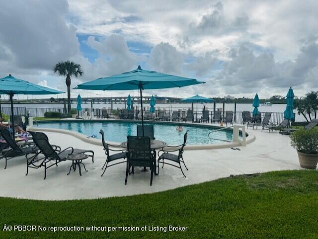 2840 South Ocean Boulevard, Unit 3170 Palm Beach, FL 33480 - Photo 30 of 30 a view of a patio with a table chairs and a fire pit