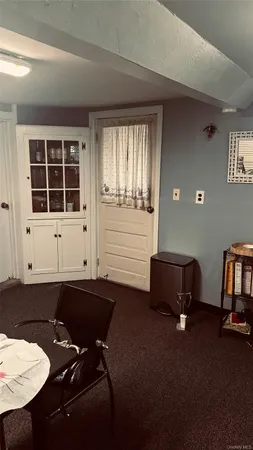 a room with table chairs and window