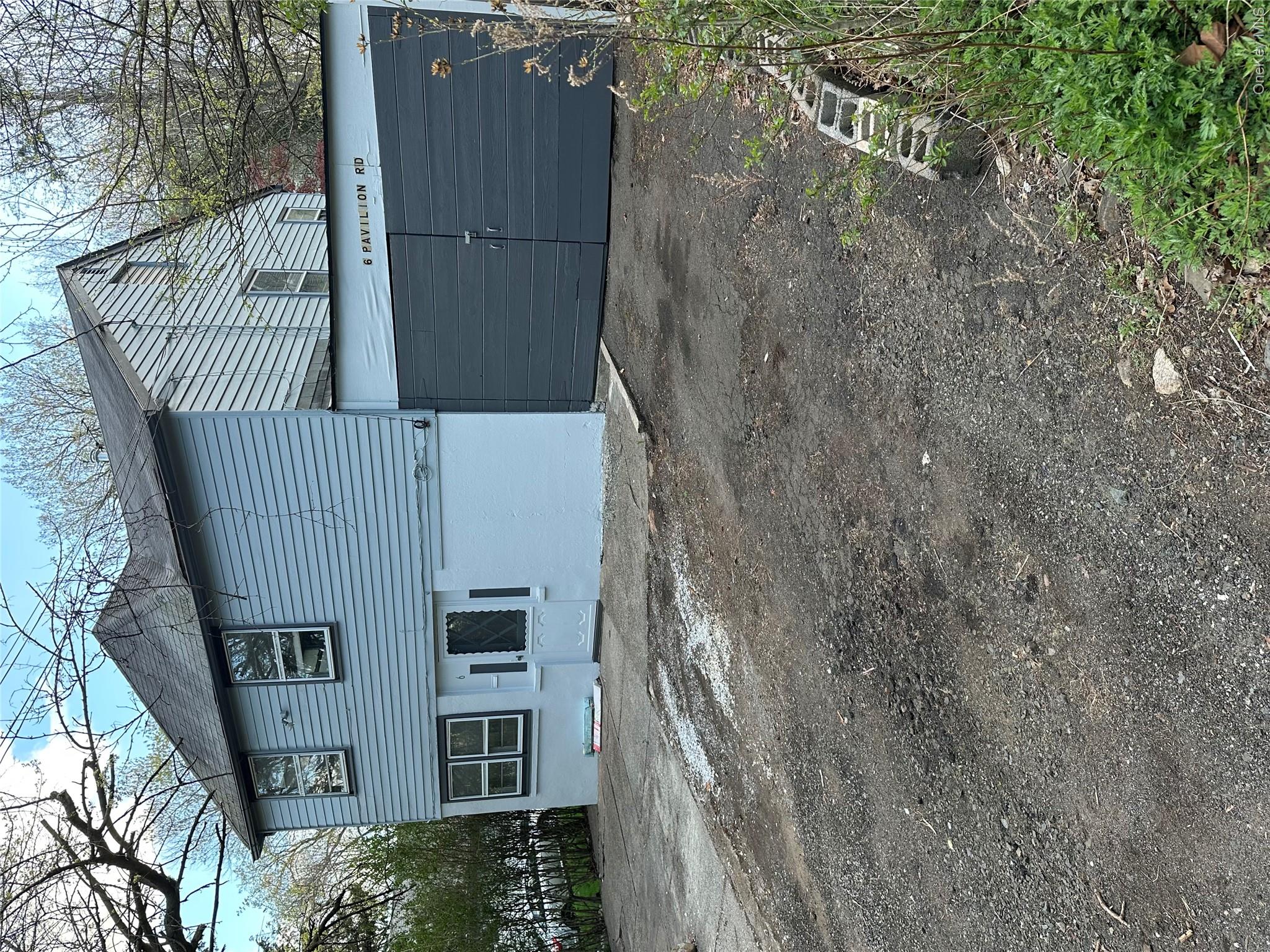 6 Pavilion Road Suffern, NY 10901 - Photo 6 of 13 a front view of a house with a yard and garage