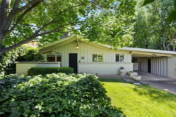 a front view of house with yard outdoor seating and green space