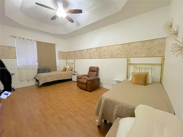 a bedroom with two beds and painting on the wall