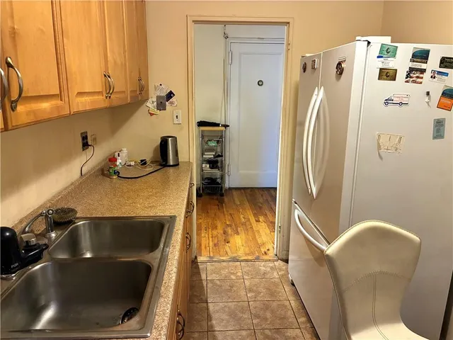 a kitchen with a refrigerator and a sink