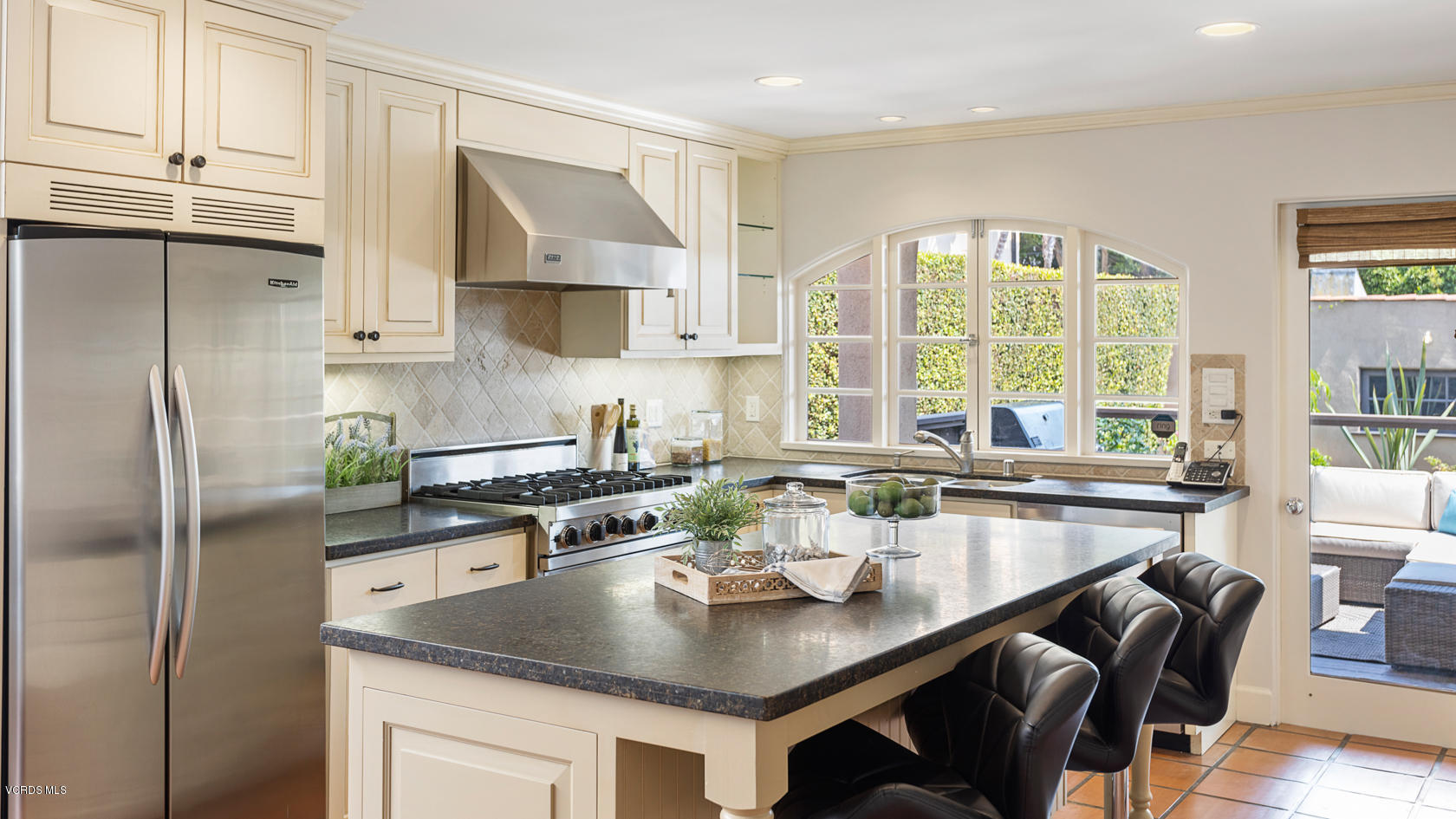 12252 Gorham Avenue Los Angeles, CA 90049 - Photo 17 of 59 a kitchen with a refrigerator a sink a stove and white cabinets