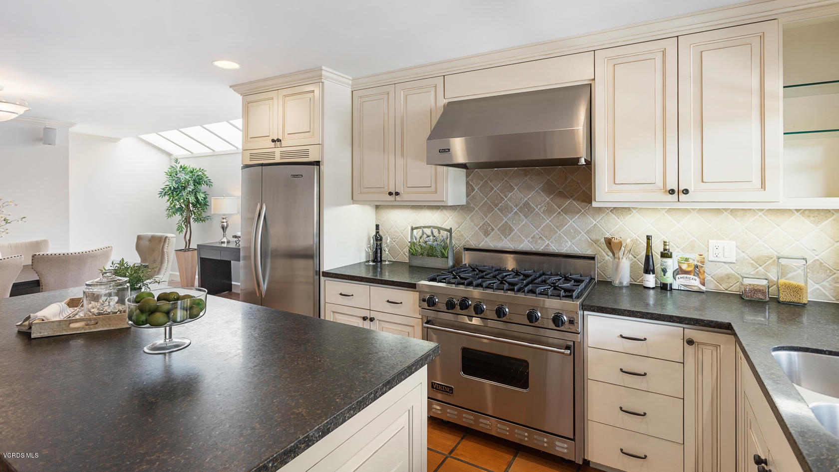 12252 Gorham Avenue Los Angeles, CA 90049 - Photo 19 of 59 a kitchen with stainless steel appliances granite countertop a stove a sink and a refrigerator