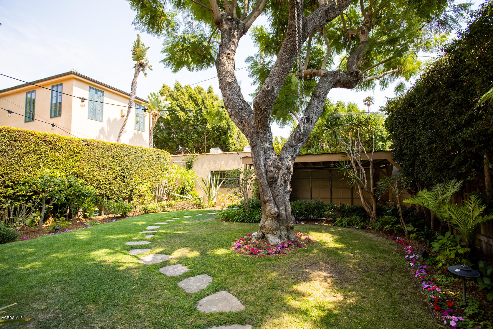 12252 Gorham Avenue Los Angeles, CA 90049 - Photo 26 of 59 a front view of a house with a yard