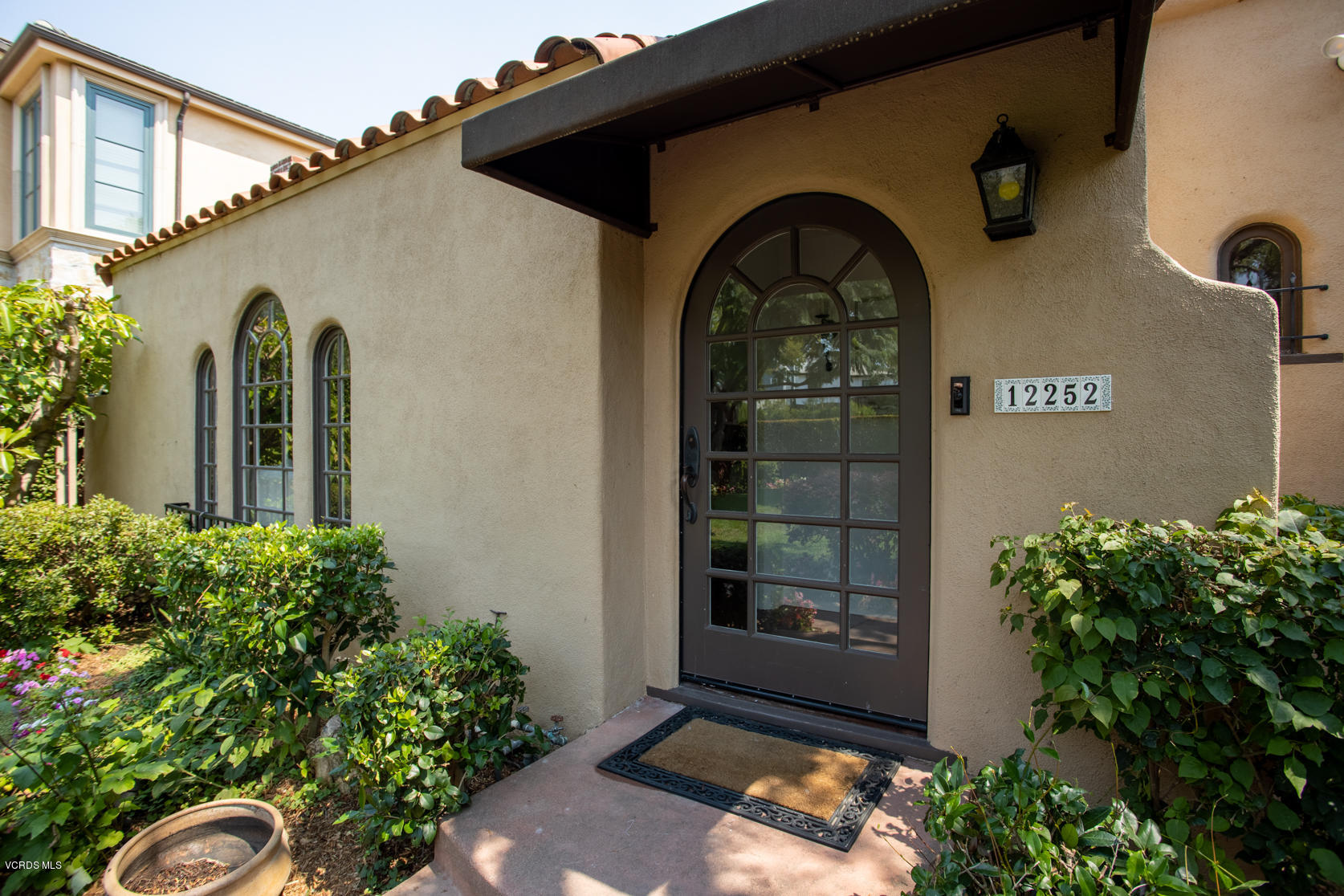 12252 Gorham Avenue Los Angeles, CA 90049 - Photo 6 of 59 a front view of a house with plants