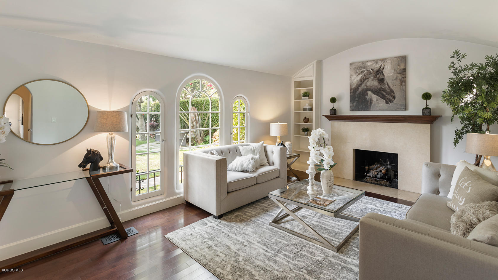 12252 Gorham Avenue Los Angeles, CA 90049 - Photo 9 of 59 a living room with furniture a fireplace and a large window