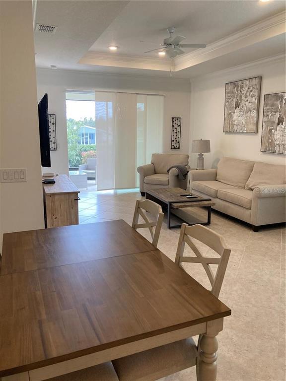 9877 Southwest 99th Loop Ocala, FL 34481 - Photo 3 of 10 a living room with furniture wooden floor and a flat screen tv