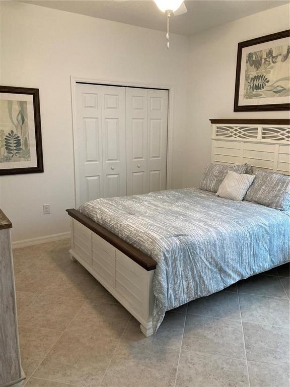 9877 Southwest 99th Loop Ocala, FL 34481 - Photo 4 of 10 a bedroom with a bed and painting on the wall